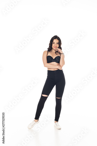 full length view of smiling sexy girl in black bra and pants isolated on white
