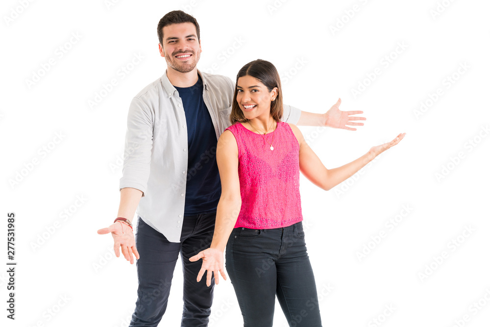 Happy Young Couple Enjoying Against White Background Happy Young Couple Enjoying Against White Background