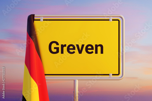 Greven. Gelbes Schild/Ortsschild. Flagge von Deutschland hängt darüber. Himmel mit Sonnenuntergang oder Sonnenaufgang photo
