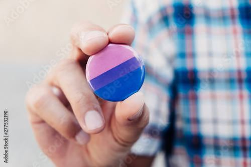 man with a bisexual pride flag badge. photo