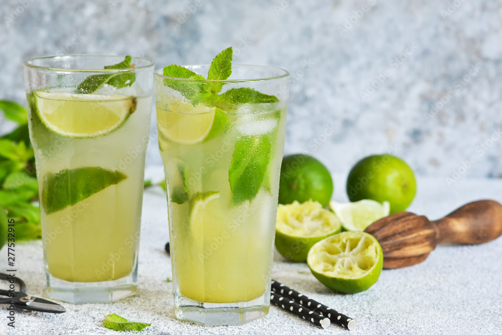 Mojito is a traditional summer cold drink with lime, mint and alcohol. Summer drink. Mojito is a traditional summer cold drink with lime, mint and alcohol. Summer drink.
