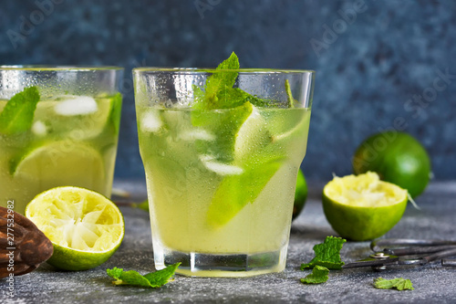 Summer cold drink - mahito with lime and mint on a concrete dark background.