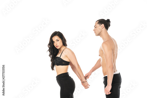 shirtless man with sexy girlfriend in handcuffs isolated on white