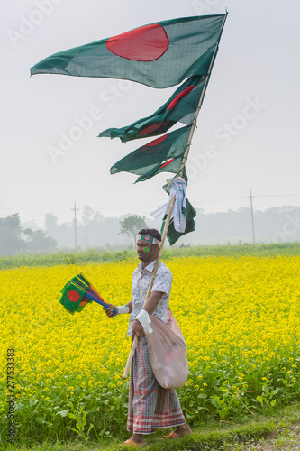 A Hawker sells Bangladeshi national flags photo