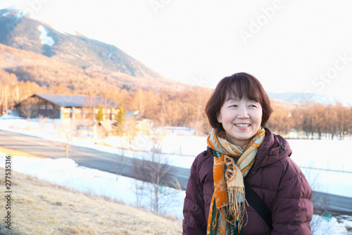 An older lady smiling while looking at the Winter scenery