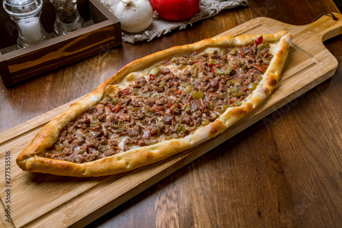 Turkish pide with meat on the board photo