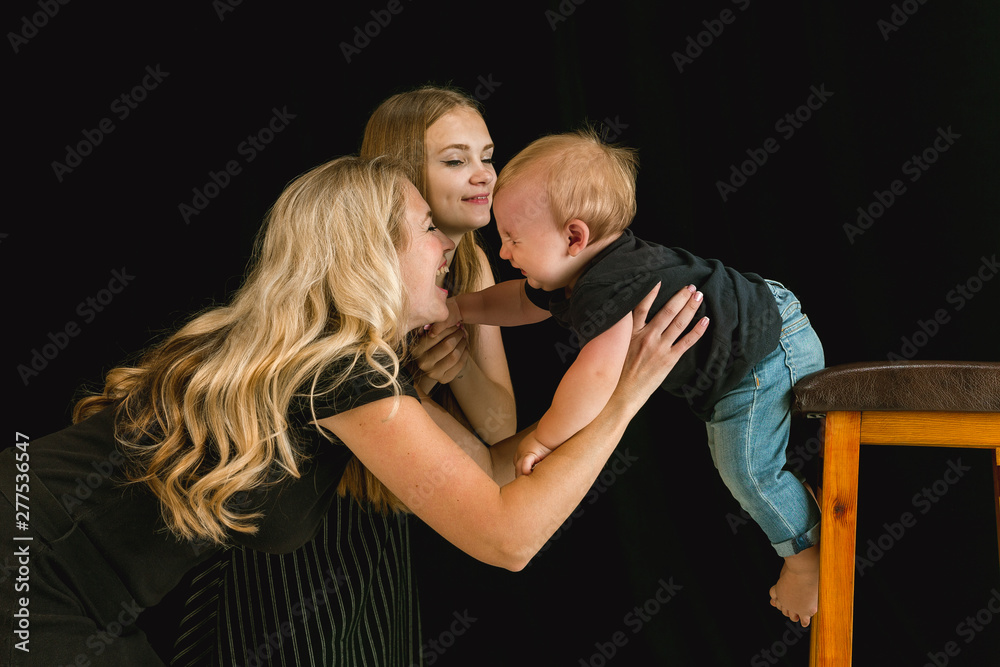 Young family spending time together and smiling. Mom with young daughter and little son playing and laughting. Family lifestyle. Mother's, father's day, togetherness, parenthood, kid's rights concept. Young family spending time together and smiling. Mom with young daughter and little son playing and laughting. Family lifestyle. Mother's, father's day, togetherness, parenthood, kid's rights concept.