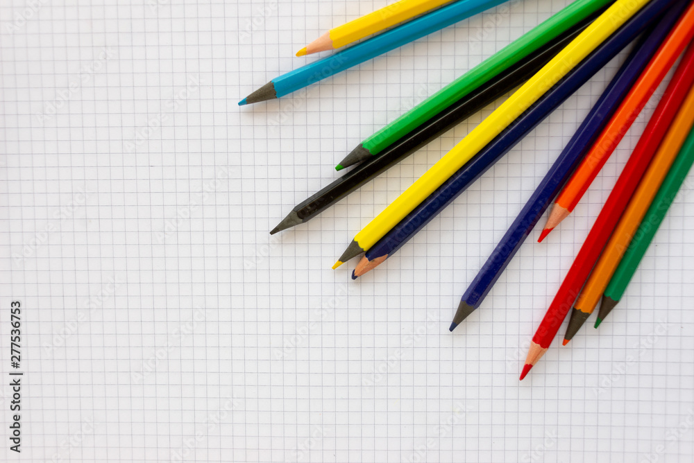 A blank sheet of paper in the box on it are colored pencils. A blank sheet of paper in the box on it are colored pencils.