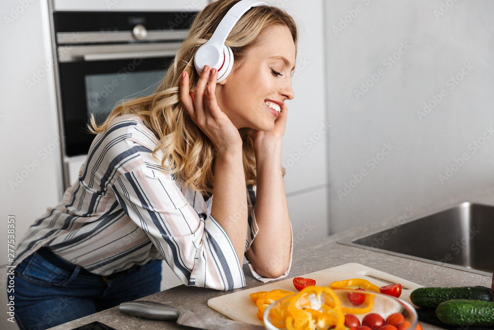 Beautiful young woman listening to music with headphones