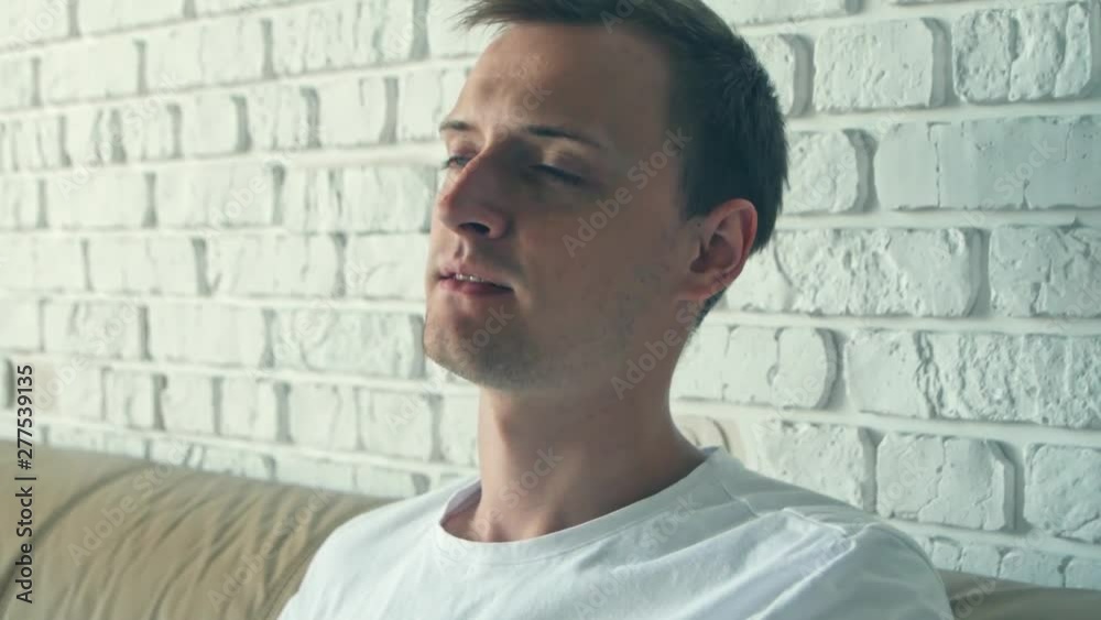 Beautiful young caucasian man drinks coffee in the morning. Close-up portrait. Beautiful young caucasian man drinks coffee in the morning. Close-up portrait.