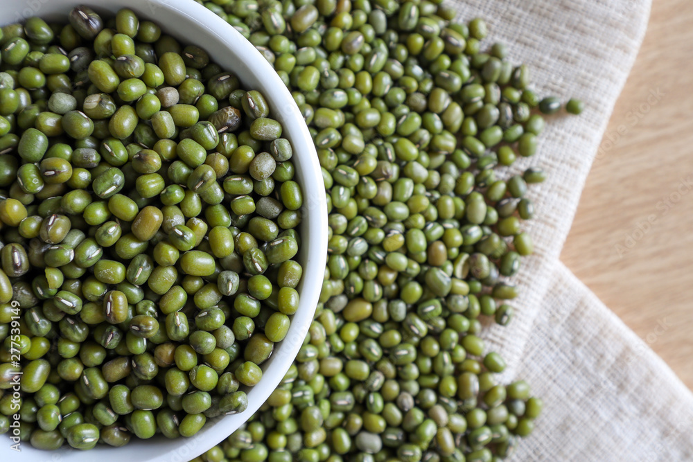 Mung bean seeds have long been used as food for human beings, green beans, seeds that are placed in a white plate, placed on a table with tears and tablecloths.... Mung bean seeds have long been used as food for human beings, green beans, seeds that are placed in a white plate, placed on a table with tears and tablecloths....