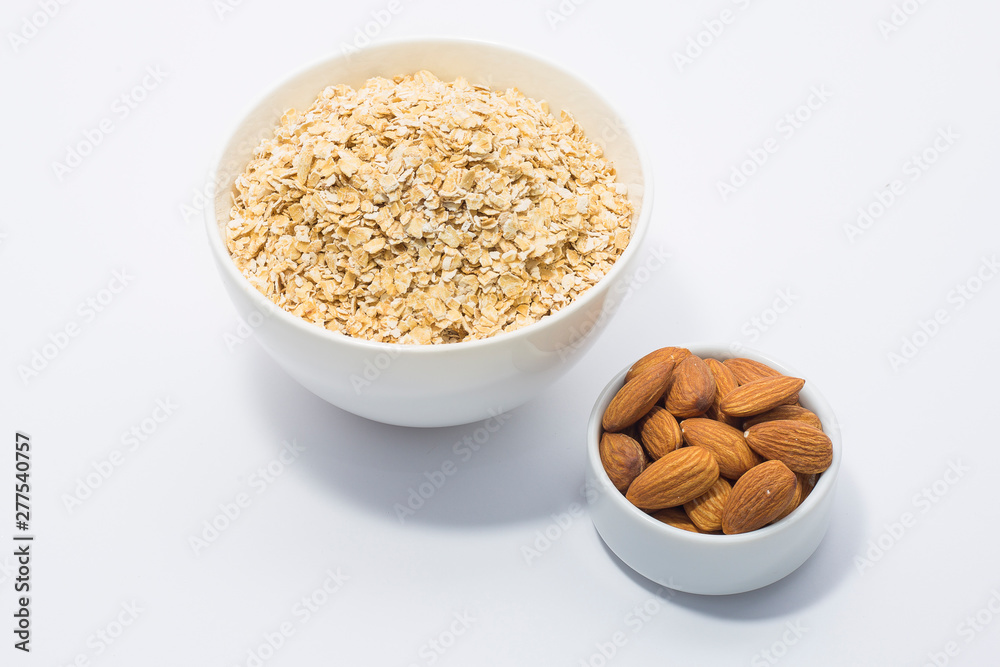 Healthy breakfast ingredients glass of milk, Almond nut and oats Healthy breakfast ingredients glass of milk, Almond nut and oats