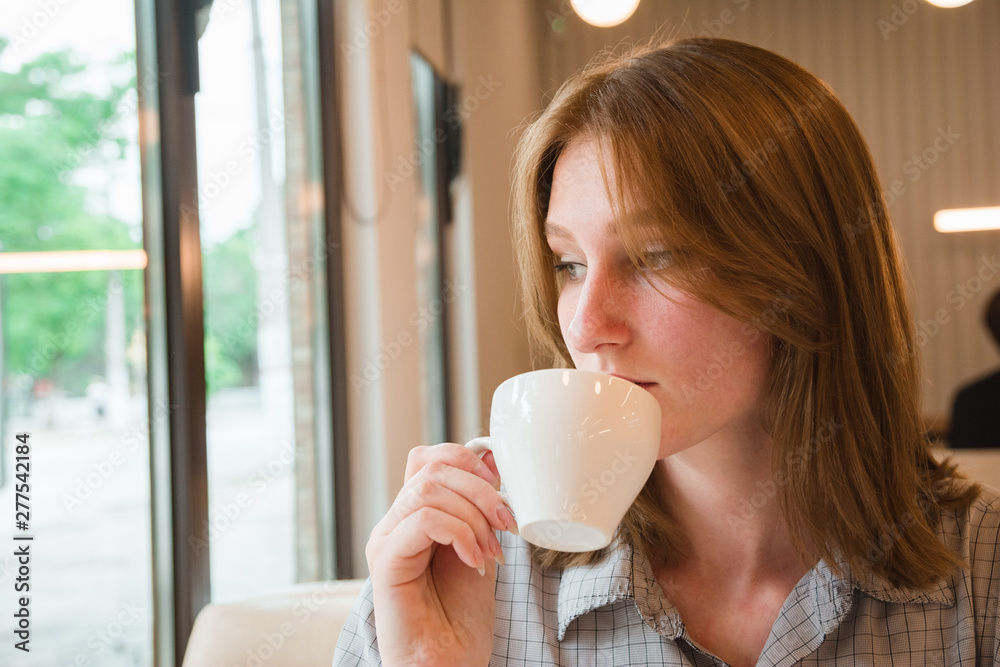 Girl is waiting for a meeting in cafe Girl is waiting for a meeting in cafe