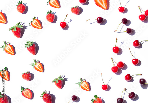 Strawberry and Cherry pattern frame on the noon light. Top view fresh berries on the white background. Copy space.