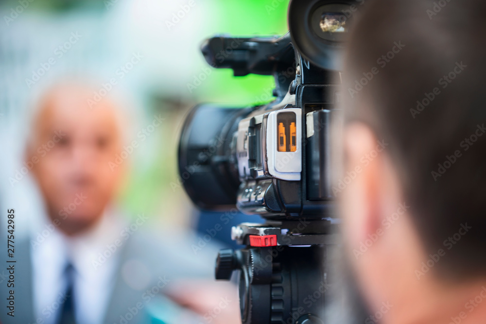 Press Conference Outdoors. Cameraman at a Media Event