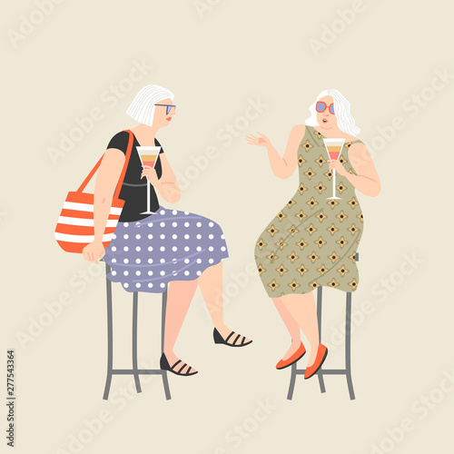 Two old ladies drinking wine and chatting. Active lifestyle