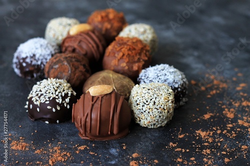 Homemade chocolate candies for Valentine's Day on dark background.