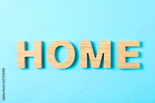 Word House lined with wooden letters on color background, top view
