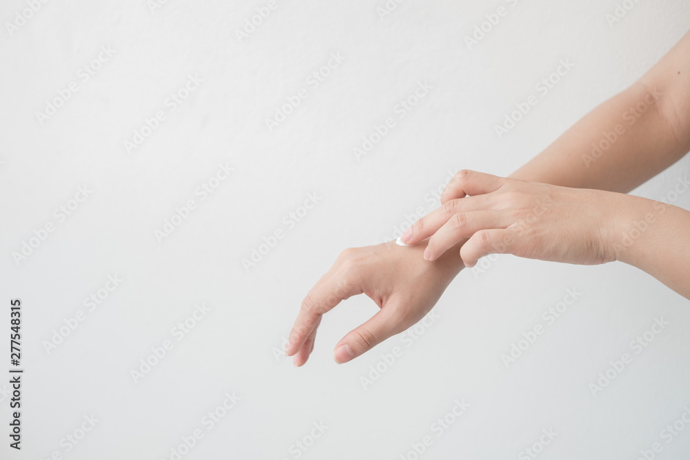 Closeup of beautiful female hands holding hands and applying a moisturizer. Beauty woman's hand applying cream. Closeup of beautiful female hands holding hands and applying a moisturizer. Beauty woman's hand applying cream.