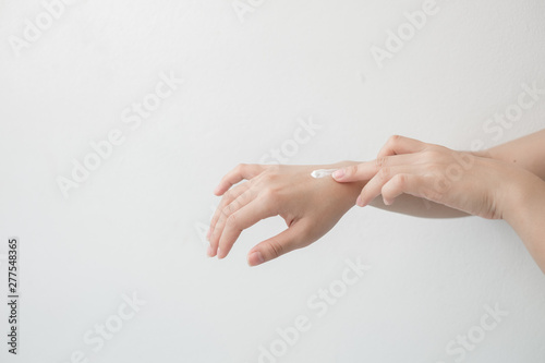 Closeup of beautiful female hands holding hands and applying a moisturizer. Beauty woman's hand applying cream.