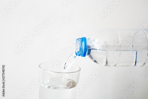 Pouring drinking water in a glass White background