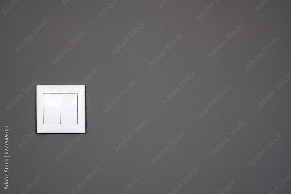 Switches on a dark gray background, switches on gray wall. Home electrical switch Switches on a dark gray background, switches on gray wall. Home electrical switch
