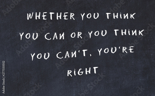 Black chalkboard with handwritten wise motivational quote 