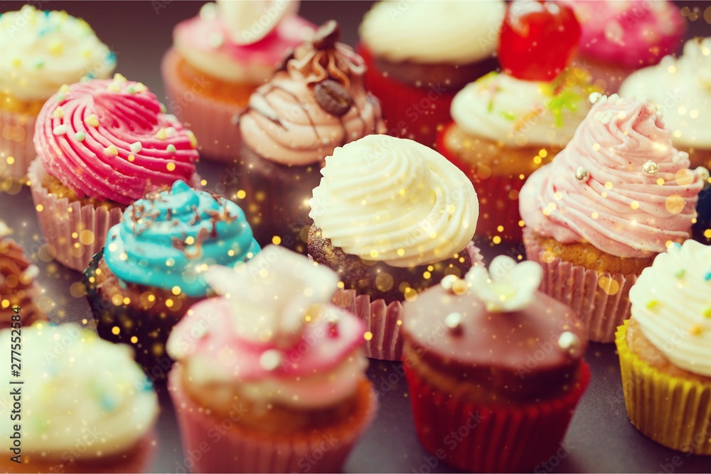 Tasty Colorful cupcakes on background