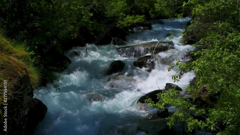 View of a waterfall in a mountain stream View of a waterfall in a mountain stream