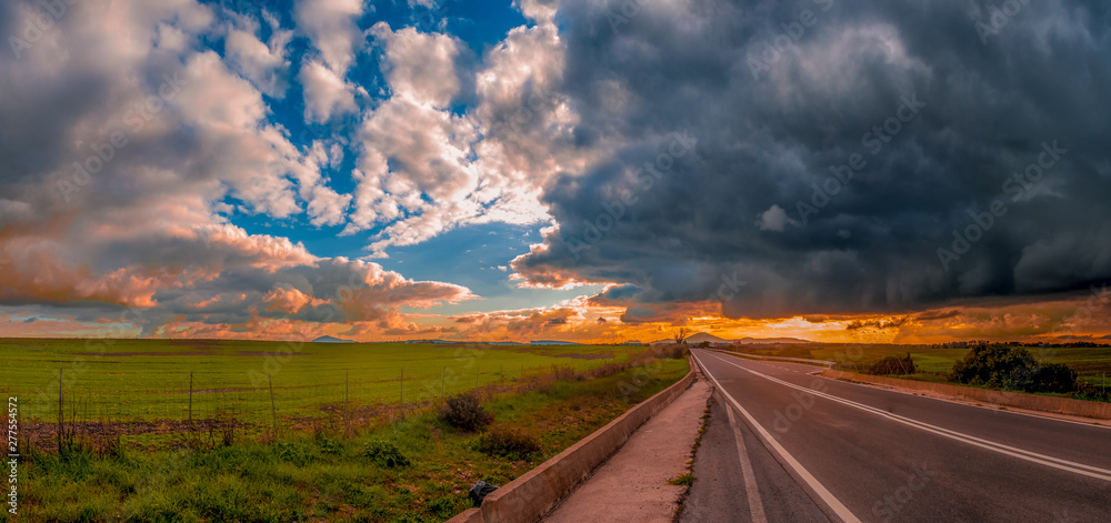 Deserted road under a dramatic sky