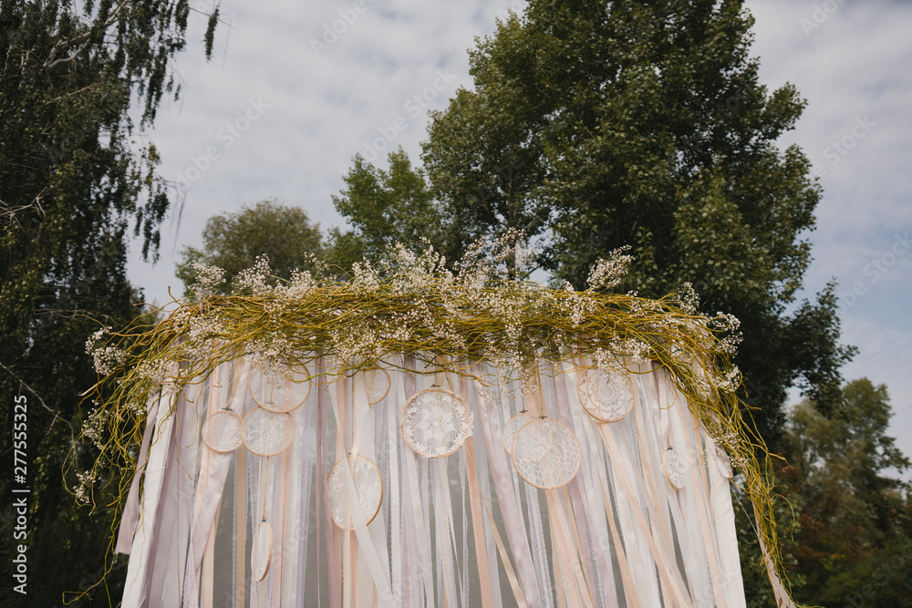 Fototapeta premium Coziness and style. Modern event design. Lounge zone and european traditional wedding ceremony decoration outdoors in the restaurant before the reception.