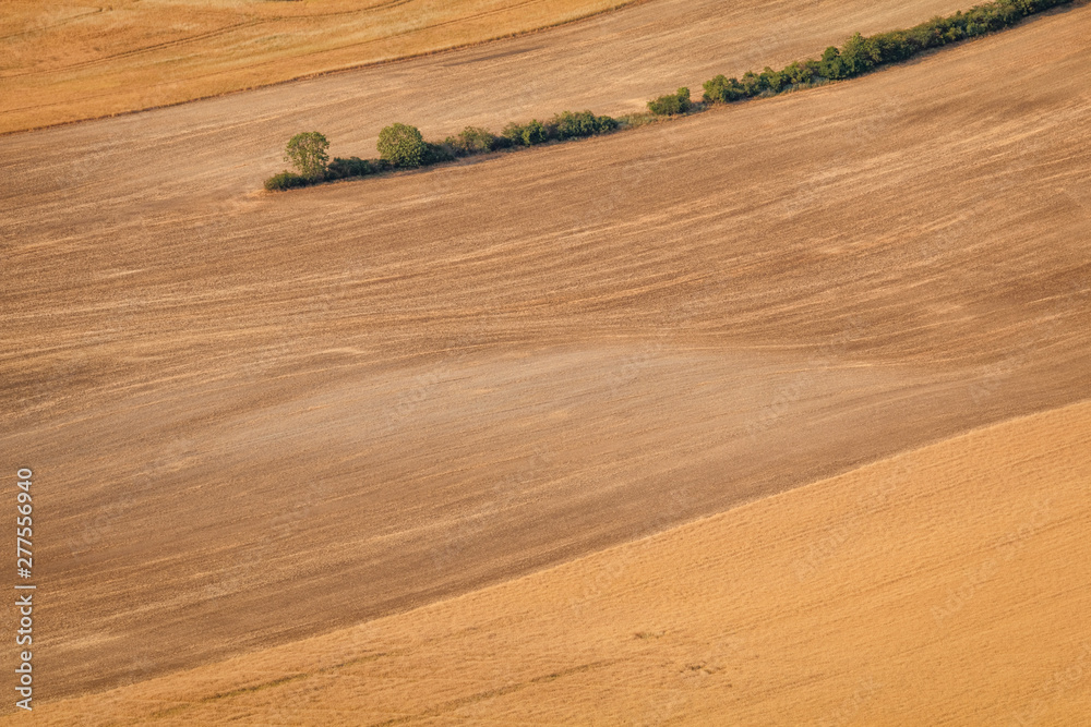 Agricultural summer. Natural Landscape In Brown And Yellow Colors of Ceske stredohori at the sunset, Czechia