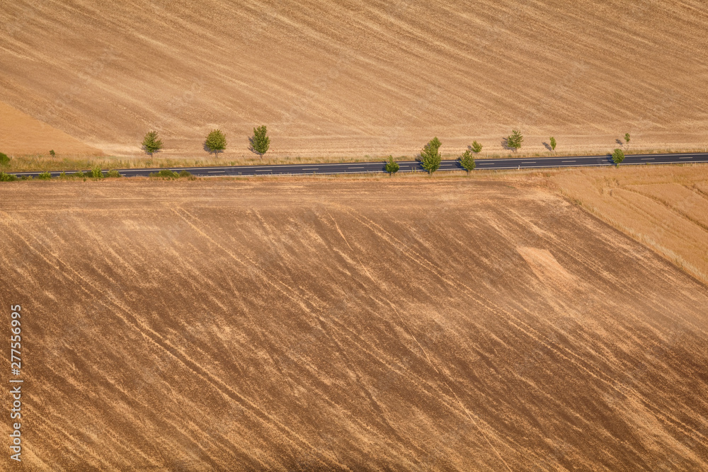 Agricultural summer. Natural Landscape In Brown And Yellow Colors of Ceske stredohori at the sunset, Czechia