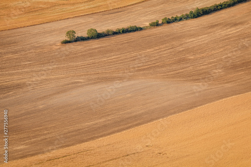 Obraz na płótnie Agricultural summer. Natural Landscape In Brown And Yellow Colors of Ceske stredohori at the sunset, Czechia w salonie