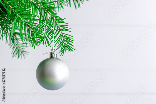 Christmas toy hanging on a branch of spruce decoration isolated on the white.