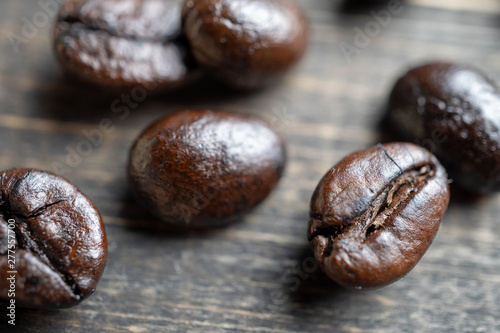 close up Coffee beans on wooden table. Copy space for text and content.