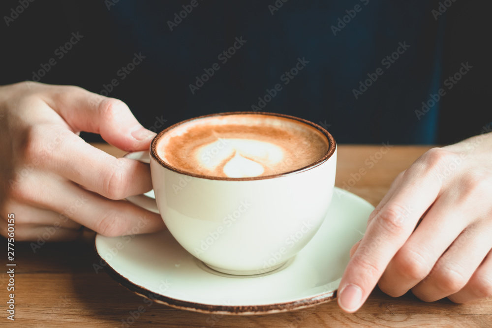 Fototapeta A cup of cappuccino in man's hands. Aroma coffe. Morning.