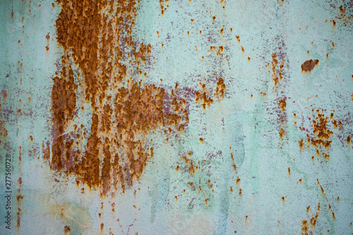 Old corroded metal wall background with flaky blue green paint .Rusty flaky cracked metal surface.Abstract the surface texture of the old metal.