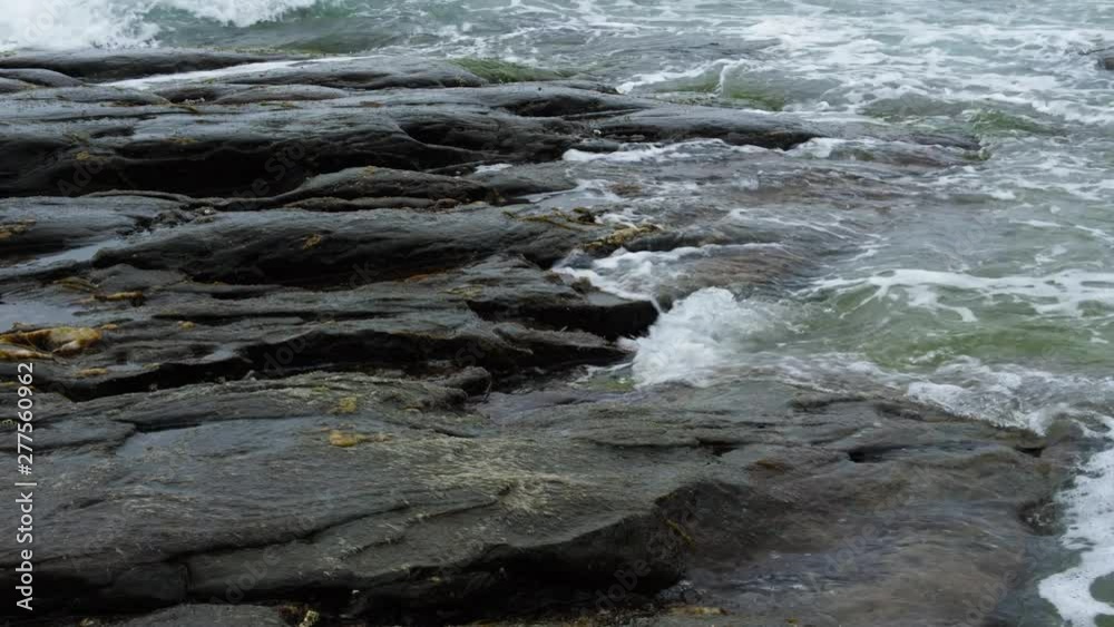 STEADY CLOSE UP STEADY Sea waves hitting the rocky beach of Stavanger in Norway STEADY CLOSE UP STEADY Sea waves hitting the rocky beach of Stavanger in Norway