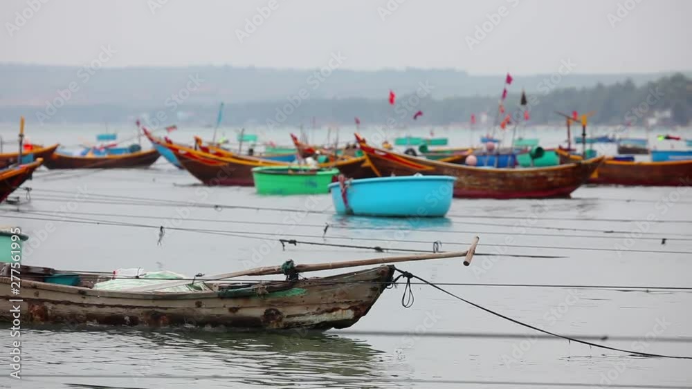 Colorful fishing boat float on the sea at town port in Mui ne, Vietnam - sunset view Colorful fishing boat float on the sea at town port in Mui ne, Vietnam - sunset view