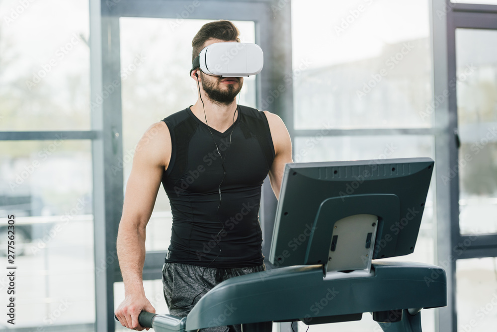 sportsman in virtual reality headset running on treadmill at gym