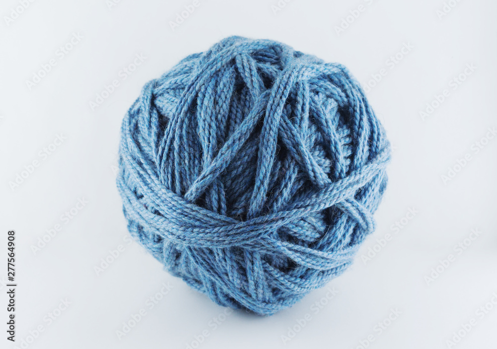 A large ball of blue wool. Cozy accessories. Materials for knitting. A large ball of blue wool. Cozy accessories. Materials for knitting.