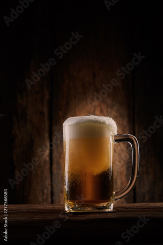 Beer in mug on wooden table