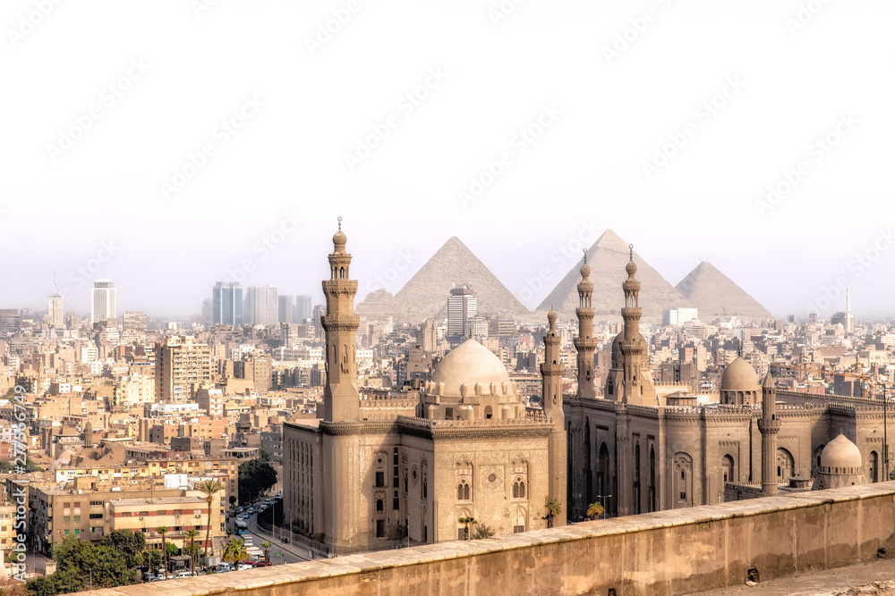 View on the Mosque-Madrassa of Sultan Hassan in Cairo and the Pyramids of Giza, Egypt