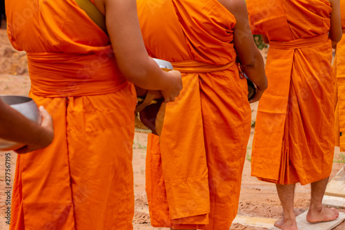 There was a merit making in the morning. People would scoop food into the alms of many monks. © S@photo