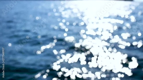 Bokeh reflection from sunlight on the surface of ocean waves. Beautiful serenade bokeh background.