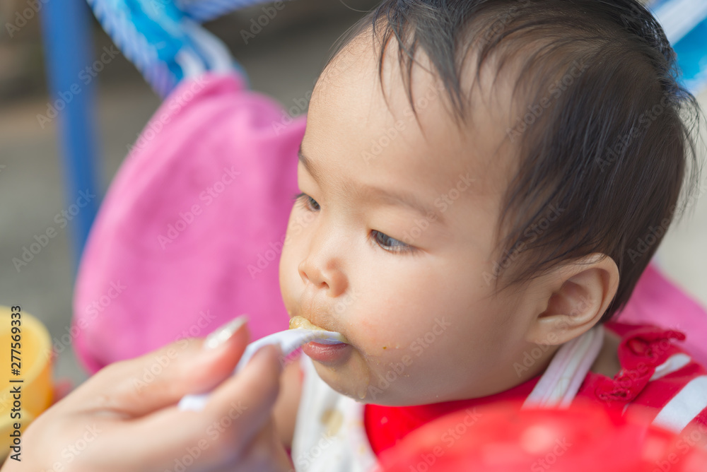Cute asian baby girl eatting rice with mom,Thailand people,Time for foods Cute asian baby girl eatting rice with mom,Thailand people,Time for foods