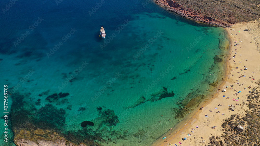 Aerial drone bird's eye view photo of iconic turquoise clear water sandy beach of Agios Sostis in island of Mykonos, Cyclades, Greece