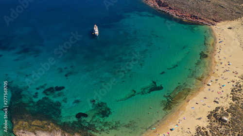 Aerial drone bird s eye view photo of iconic turquoise clear water sandy beach of Agios Sostis in island of Mykonos  Cyclades  Greece
