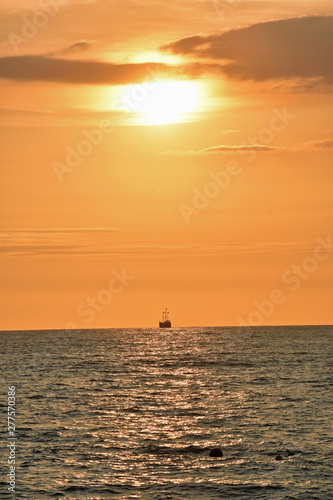 Golden Sunset at the Beach with Boat © LaDonna